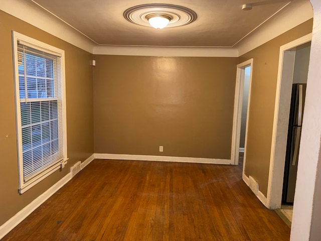 unfurnished room with dark hardwood / wood-style flooring