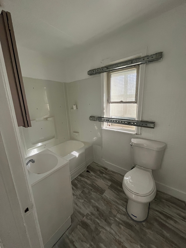 bathroom featuring wood-type flooring, vanity, and toilet