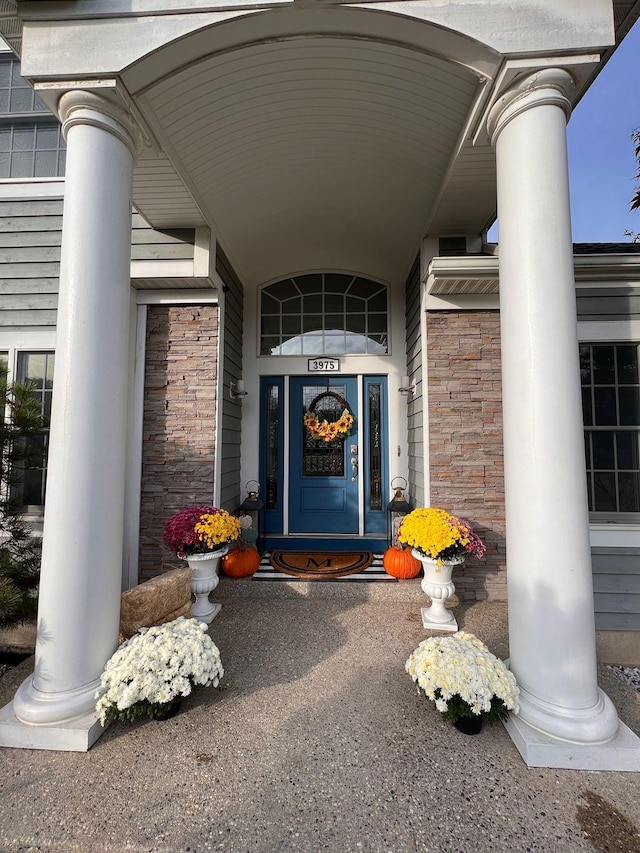 3975 Harbor Breeze Dr, Norton Shores, MI 49441 - doorway to property with stone siding