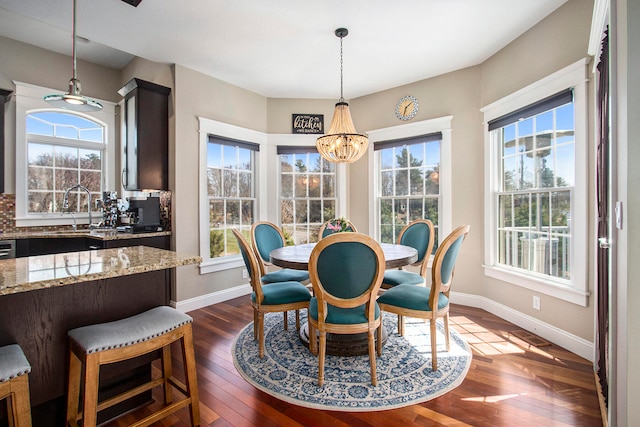 3975 Harbor Breeze Dr, Norton Shores, MI 49441 - dining room featuring a chandelier, dark wood-style flooring, and baseboards