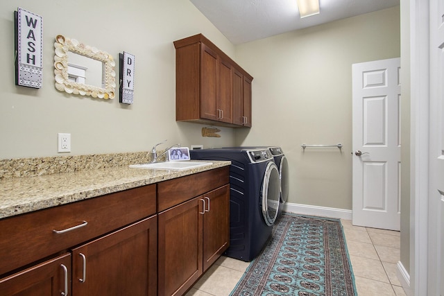 3975 Harbor Breeze Dr, Norton Shores, MI 49441 - washroom featuring cabinet space, independent washer and dryer, light tile patterned floors, and baseboards