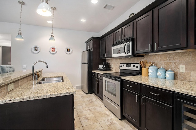 3975 Harbor Breeze Dr, Norton Shores, MI 49441 - kitchen with stainless steel appliances, a sink, tasteful backsplash, hanging light fixtures, and wine cooler