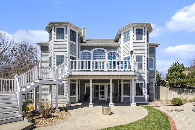 3975 Harbor Breeze Dr, Norton Shores, MI 49441 - back of house featuring stairway, a patio, a deck, and a chimney