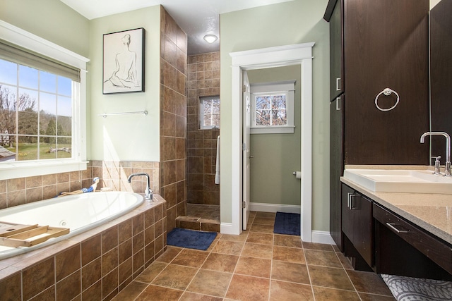 3975 Harbor Breeze Dr, Norton Shores, MI 49441 - bathroom with a tub with jets, vanity, tiled shower, baseboards, and tile patterned floors