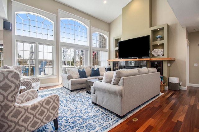 3975 Harbor Breeze Dr, Norton Shores, MI 49441 - living area featuring a towering ceiling, wood finished floors, baseboards, and recessed lighting