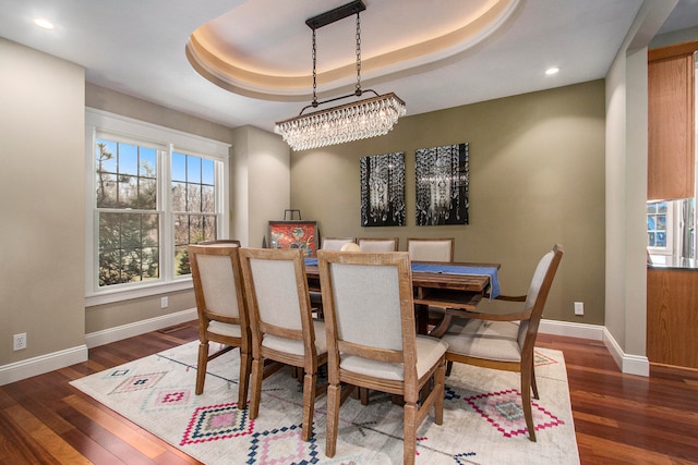 3975 Harbor Breeze Dr, Norton Shores, MI 49441 - dining area with a tray ceiling, baseboards, dark wood-style floors, and recessed lighting