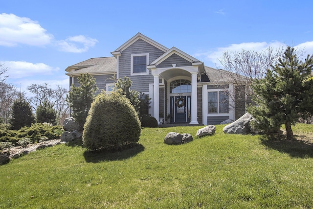 3975 Harbor Breeze Dr, Norton Shores, MI 49441 - view of front of home with a front yard and roof with shingles