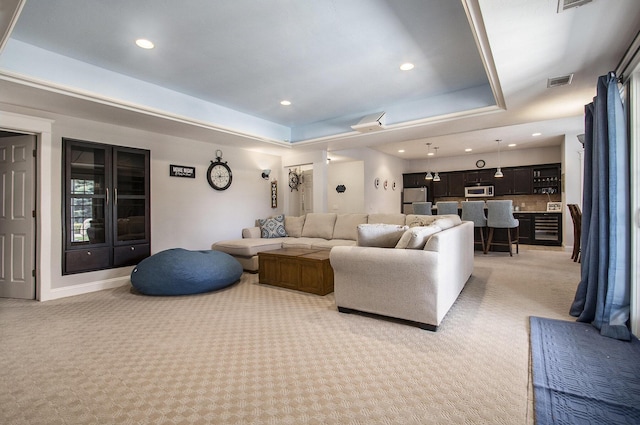3975 Harbor Breeze Dr, Norton Shores, MI 49441 - living area featuring light colored carpet, a tray ceiling, recessed lighting, and baseboards