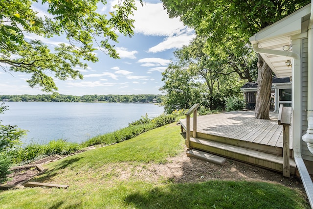 exterior space featuring a deck with water view