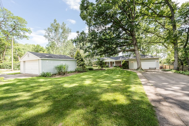 view of front of house with a front lawn, an outdoor structure, and a garage