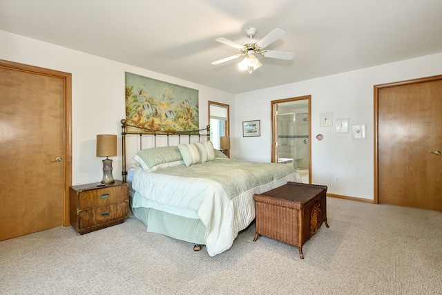 carpeted bedroom featuring ceiling fan and connected bathroom