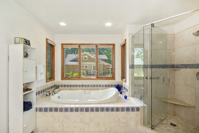 bathroom featuring shower with separate bathtub