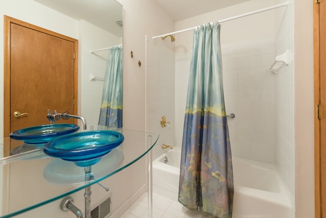 bathroom featuring tile patterned floors, shower / bath combo, and sink