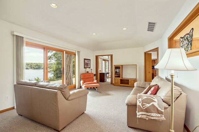 carpeted living room with a water view