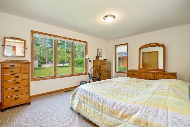 bedroom featuring light carpet