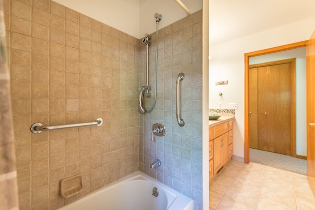 bathroom with tile patterned floors, vanity, and tiled shower / bath