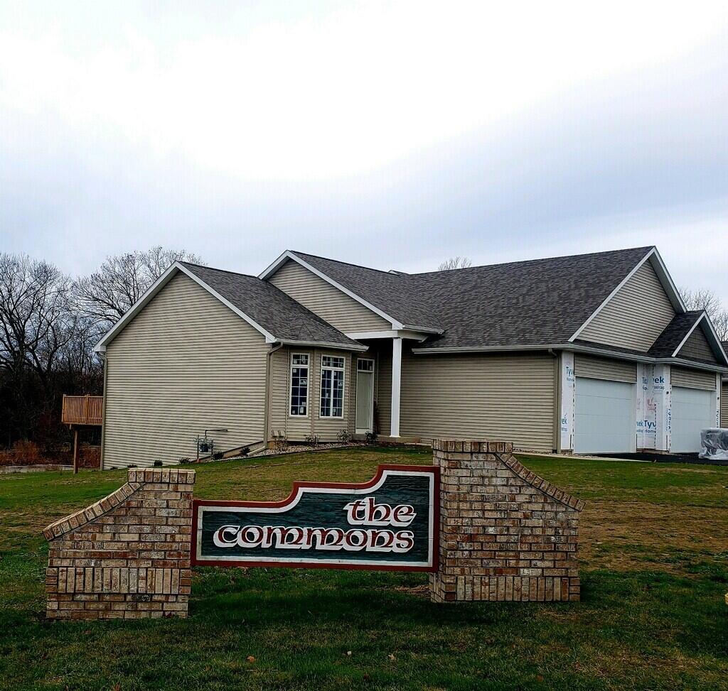 ranch-style home featuring a front lawn and a garage