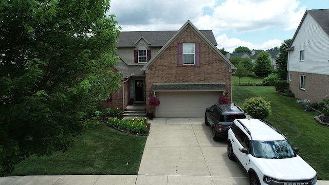 view of front of house with a garage and a front lawn