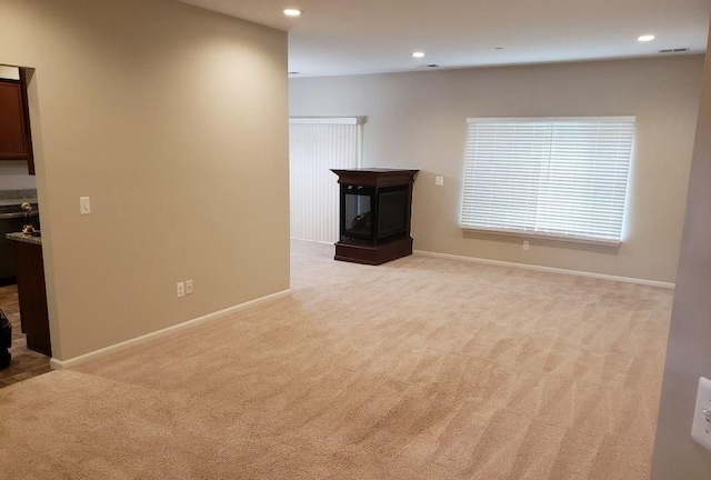 unfurnished living room featuring light carpet