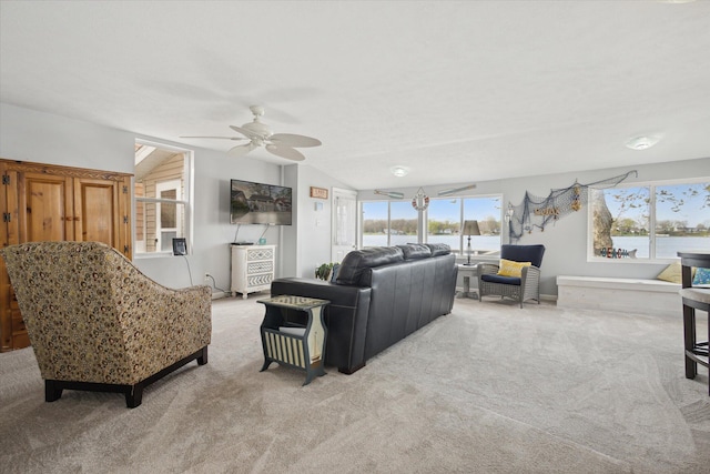 living room featuring ceiling fan, light colored carpet, and vaulted ceiling