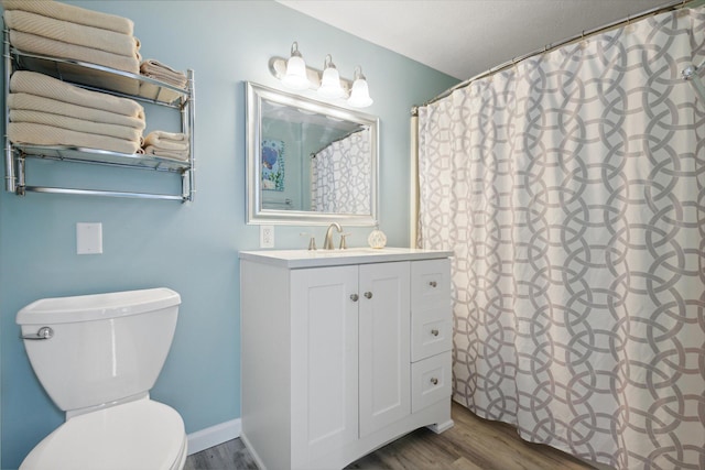 bathroom featuring hardwood / wood-style floors, vanity, toilet, and a shower with curtain