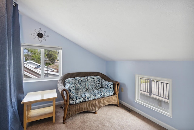 living area with carpet flooring and lofted ceiling