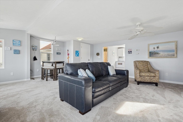 carpeted living room with ceiling fan