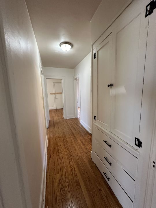 corridor featuring hardwood / wood-style floors