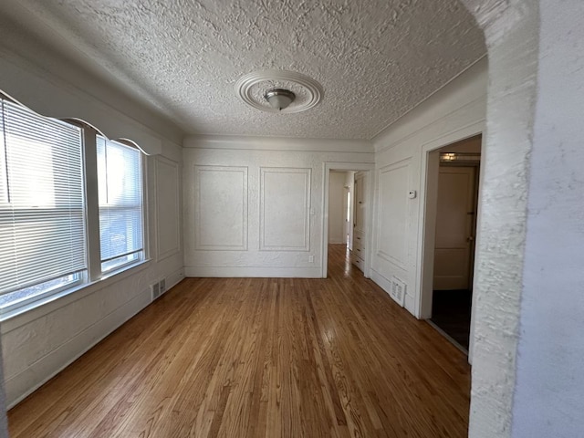 unfurnished bedroom featuring hardwood / wood-style floors and a textured ceiling