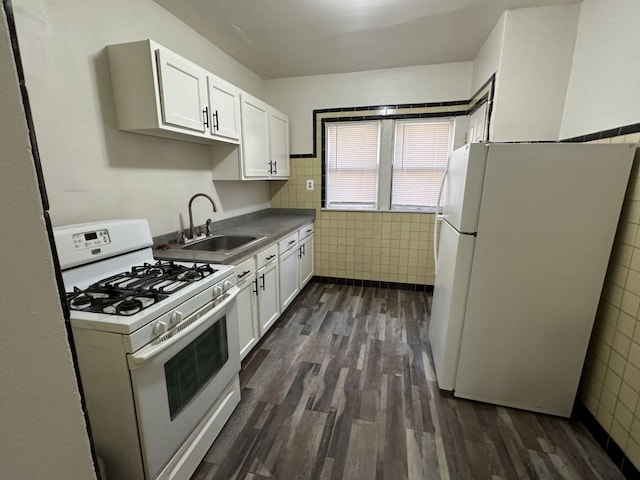 kitchen featuring tile walls, sink, white cabinets, and white appliances