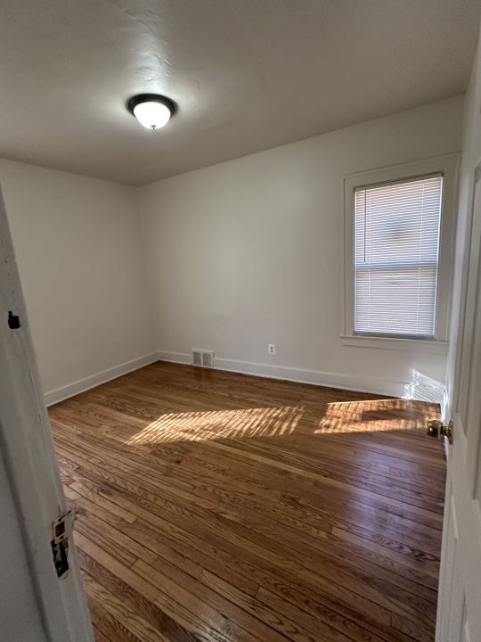 empty room featuring dark hardwood / wood-style flooring