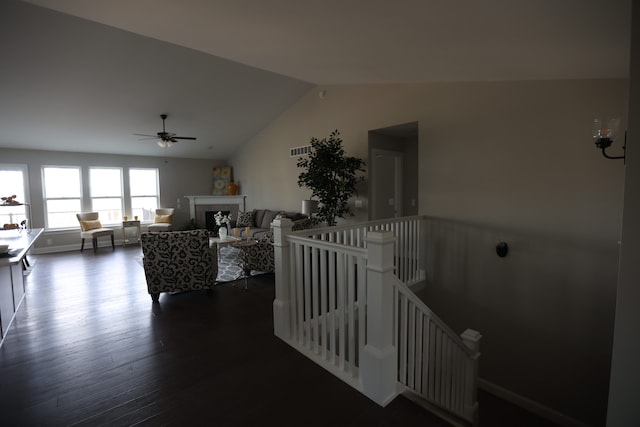 living room with ceiling fan, dark hardwood / wood-style flooring, and lofted ceiling