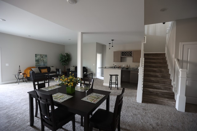 carpeted dining space with bar