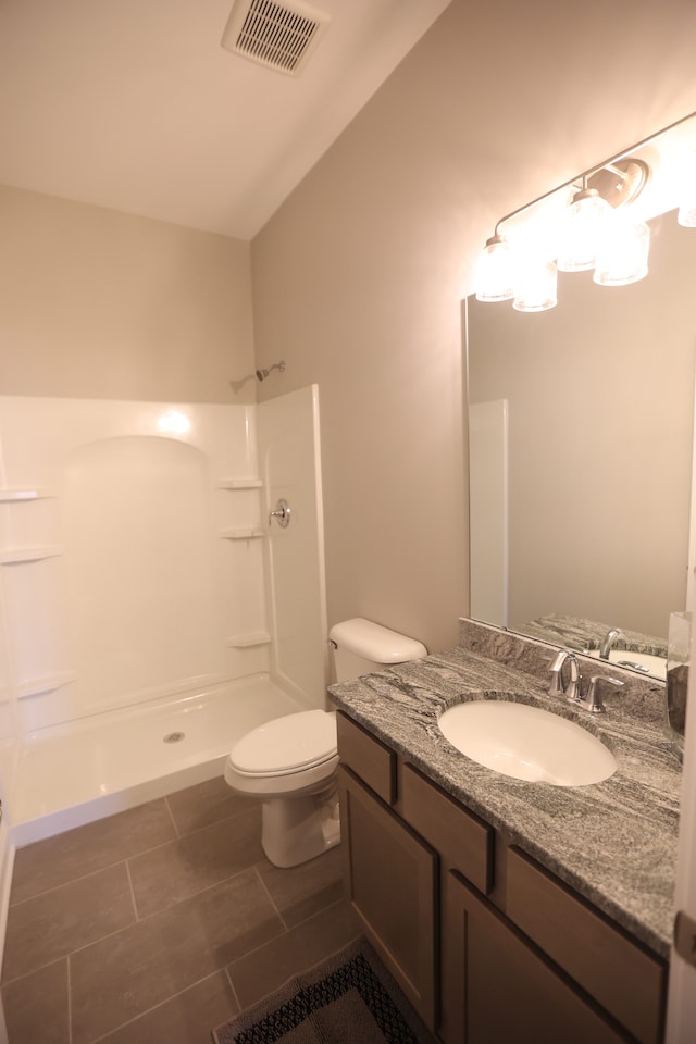 bathroom with a shower, tile patterned flooring, lofted ceiling, and toilet