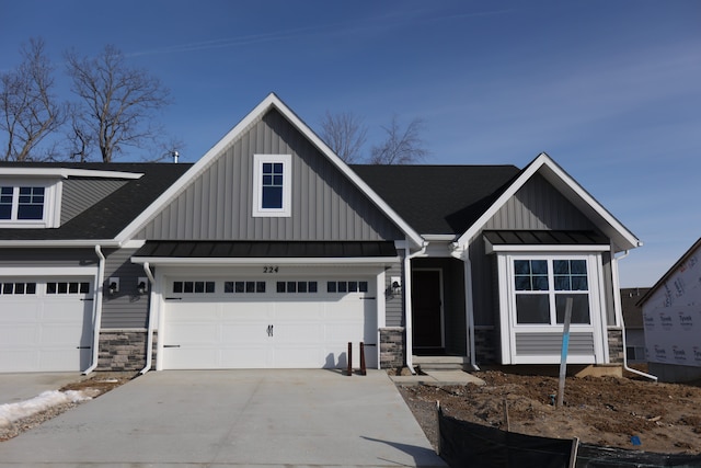 1012 Camellia Cir Unit 48, Howell, MI 48843 - view of front of house with concrete driveway, stone siding, and board and batten siding