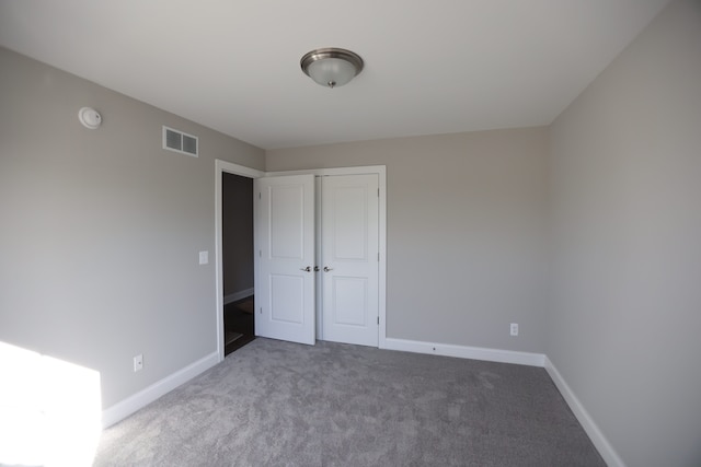 1012 Camellia Cir Unit 48, Howell, MI 48843 - unfurnished bedroom featuring carpet floors, baseboards, and a closet