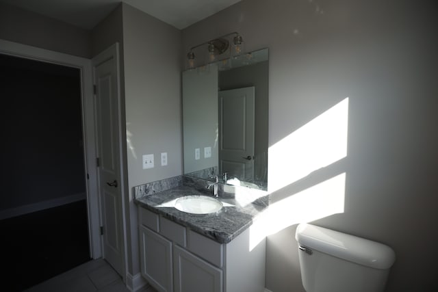 1012 Camellia Cir Unit 48, Howell, MI 48843 - half bathroom featuring vanity, toilet, and tile patterned floors