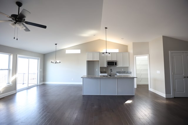 1012 Camellia Cir Unit 48, Howell, MI 48843 - kitchen featuring stainless steel microwave, a chandelier, a sink, vaulted ceiling, and baseboards