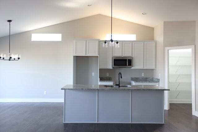 1012 Camellia Cir Unit 48, Howell, MI 48843 - kitchen featuring stainless steel microwave, a chandelier, a sink, dark wood finished floors, and high vaulted ceiling