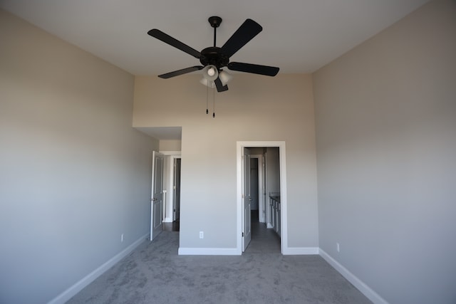 1012 Camellia Cir Unit 48, Howell, MI 48843 - unfurnished bedroom featuring a towering ceiling, carpet, baseboards, and ceiling fan