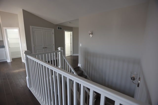 1012 Camellia Cir Unit 48, Howell, MI 48843 - corridor with an upstairs landing, dark wood-type flooring, lofted ceiling, and baseboards