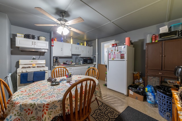 carpeted dining space with ceiling fan