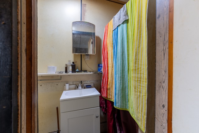 bathroom featuring vanity and curtained shower