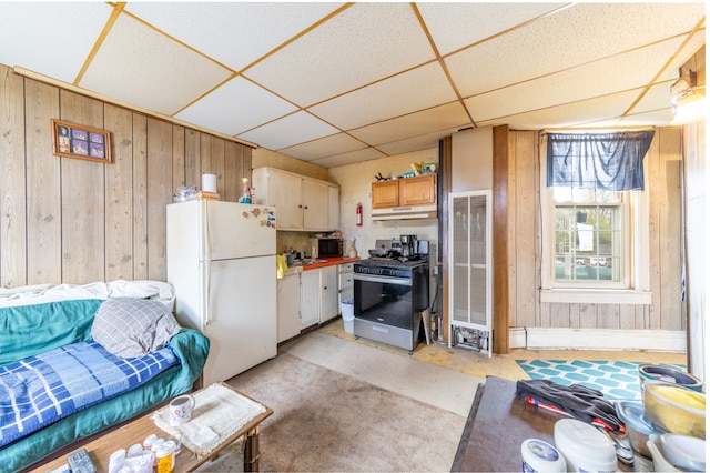 kitchen featuring a paneled ceiling, sink, white refrigerator, and stainless steel range with gas stovetop