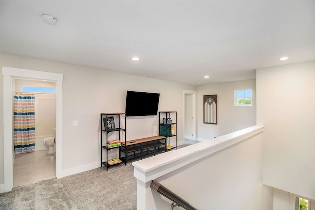 hallway featuring light carpet