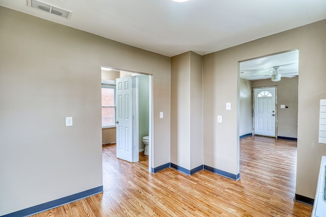 empty room featuring ceiling fan and light wood-type flooring