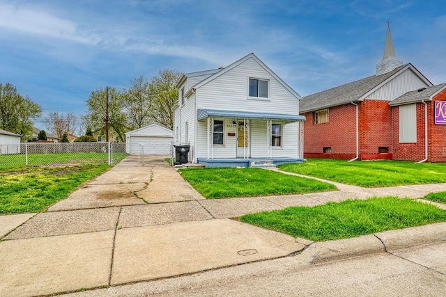 view of front of home featuring an outdoor structure, a front lawn, a porch, and a garage