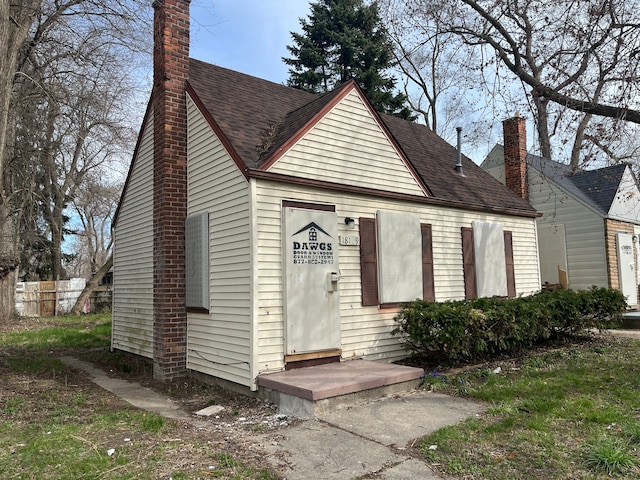 18109 Cornwall St, Detroit, MI 48224 - view of front of house with roof with shingles and a chimney