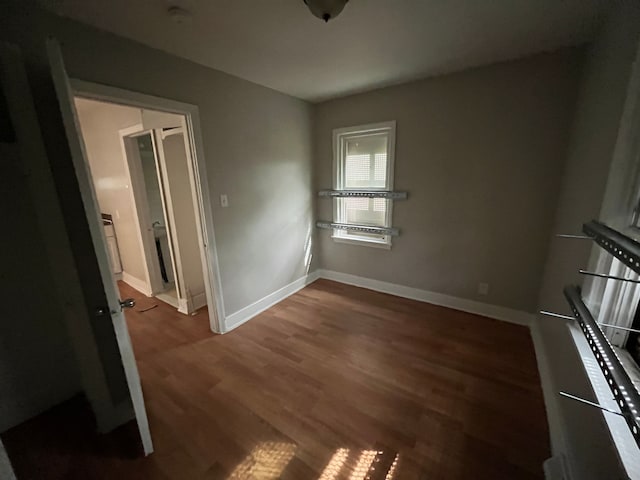 unfurnished room with dark hardwood / wood-style floors