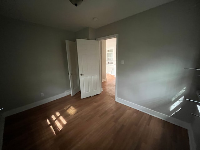 unfurnished room with wood-type flooring